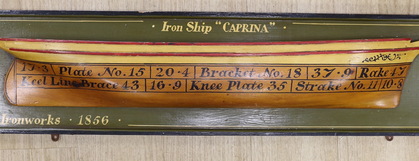 A replica painted wood ship-builder's half block model, 'Caprina' - 113cm wide